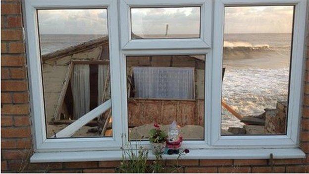 The sea seen through the front windows of a beach chalet - the rest of which has collapsed