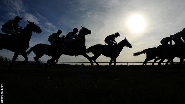 Runners and riders leave the start at Huntingdon racecourse