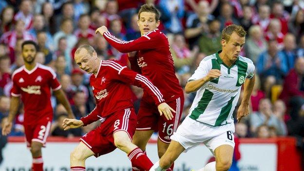 Groningen's Maikel Kietenbeld turns away from Aberdeen pair Willo Flood and Peter Pawlett