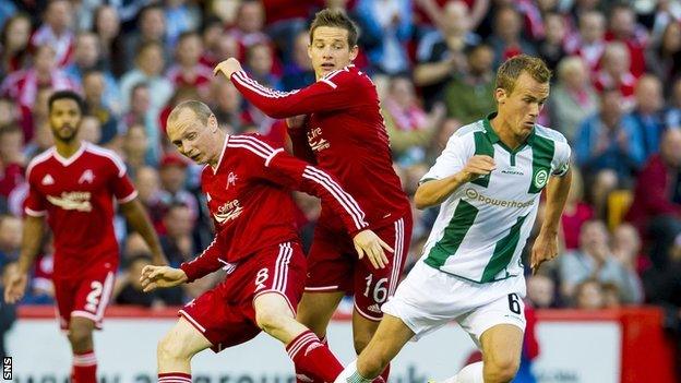 Groningen's Maikel Kietenbeld turns away from Aberdeen pair Willo Flood and Peter Pawlett