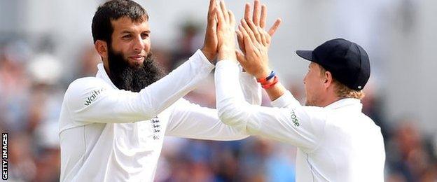 Moeen Ali and Joe Root celebrate taking Stuart Binny