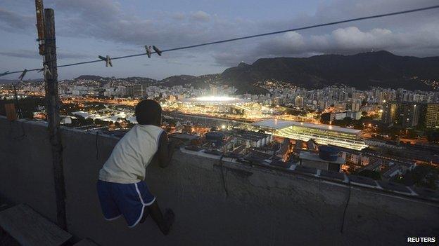 A boy watches from the Mangueira favela during the World Cup final on 13 July