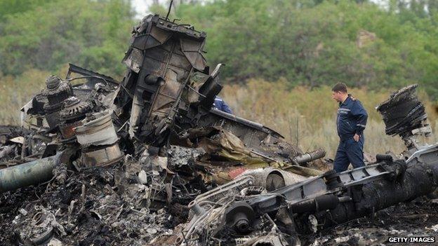 Rescuers stood among the rubble of Malaysian Airlines flight 17 in Ukraine on 18 July 2014