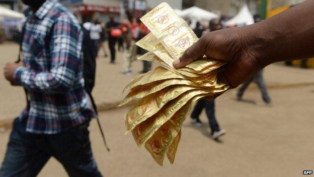 An health worker distributes condoms in the streets of Nairobi, Kenya - 14 February 2014