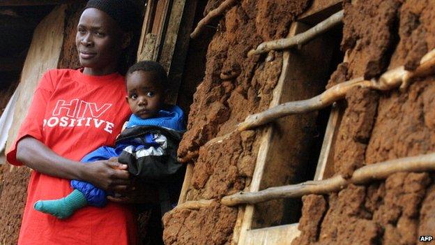 A woman with HIV holding a child in Kibera, Kenya - 2005