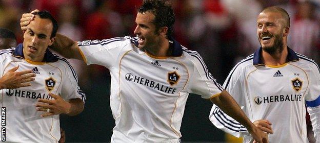 Landon Donovan of the Los Angeles Galaxy celebrates his third goal of the game with teammates Chris Klein and David Beckham