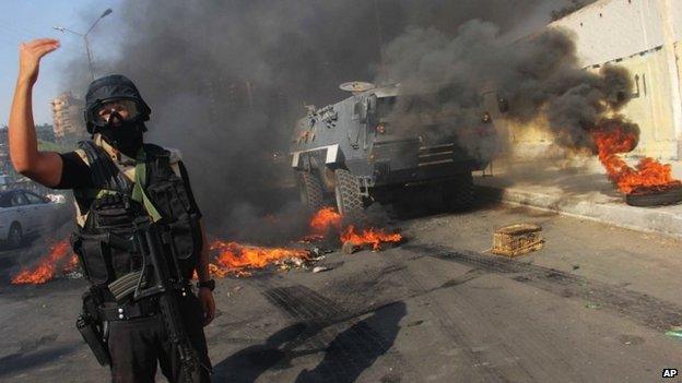 An Egyptian security forces member directs others during clashes against supporters of ousted President Mohammed Morsi in Cairo