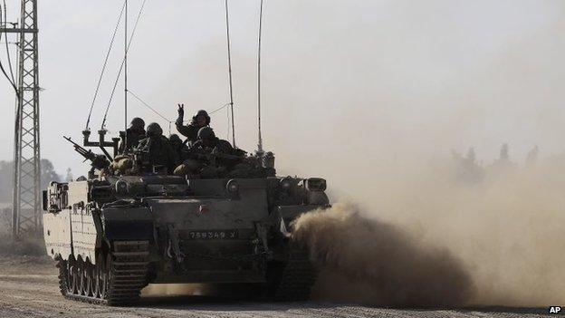 An Israeli tank rides along the border of the Israel and the Gaza Strip, 20 July 2014