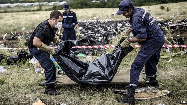 Rescue workers collect bodies of victims at the site of the crash in Grabove - 20 July 2014