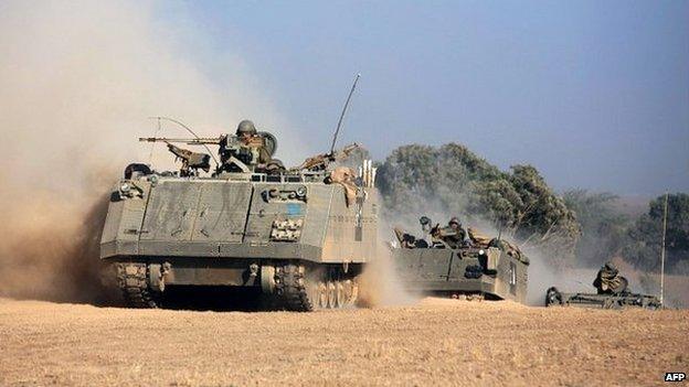 A convoy of Israeli armoured personnel carriers roll towards the Israeli-Gaza border - 20 July 2014