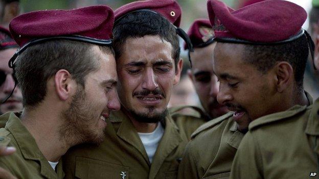 Israeli soldiers mourn during the funeral of Sgt. Bnaya Rubel at the military cemetery in Holon, Israel - 20 July 2014