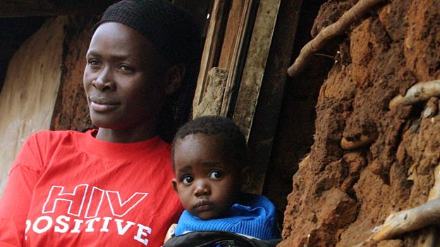 A woman with HIV holding a child in Kibera, Kenya - 2005