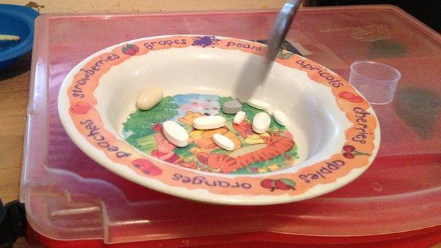 Children's bowl with pills in it