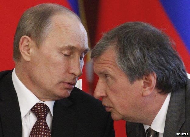 Russian President Vladimir Putin (left) talks to Rosneft President Igor Sechin