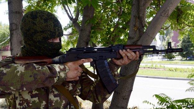 Pro-Russian militant aims Kalashnikov during combat with Ukrainian forces in eastern Ukrainian city of Donetsk. 21 July 2014