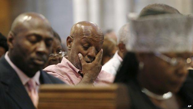 A man wiped his face at a service for Eric Garner in New York on 20 July 2014