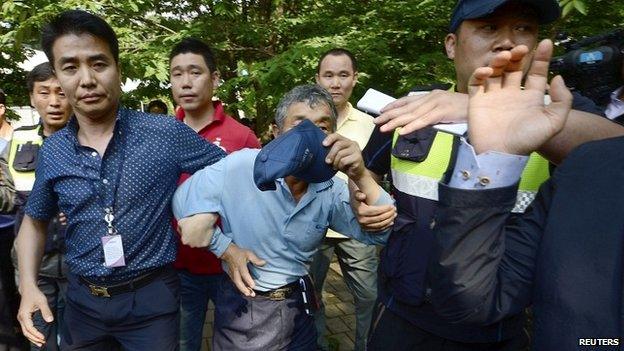 A man who is believed to have helped Yoo Byung-un to escape is detained by police at the businessman's church in Anseong - 11 June 2014