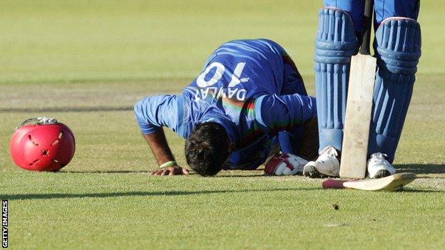 Afghanistan's Dawlat Zadran bows his head after his match-winning innings