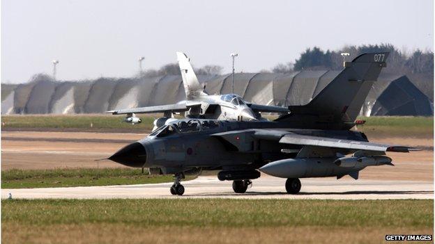 RAF jet in front of hangers