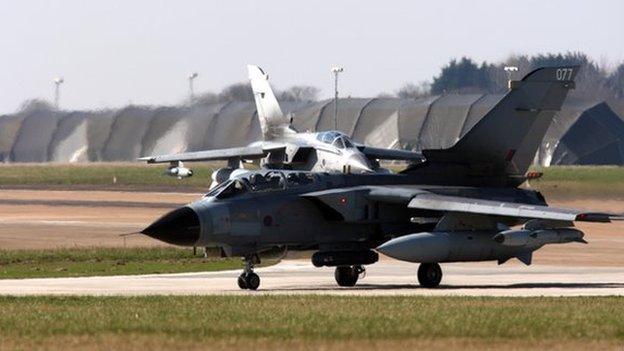 RAF jet in front of hangers