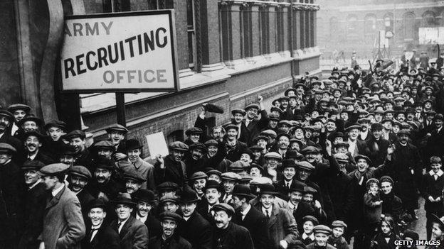 Young men wait outside an Army recruiting office in Southwark