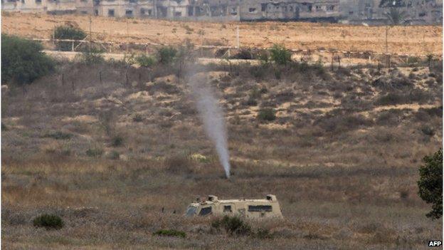 Israeli soldiers spray gas at the exit of a tunnel which was used the day before by Hamas militants to infiltrate Israeli lines, on July 22,