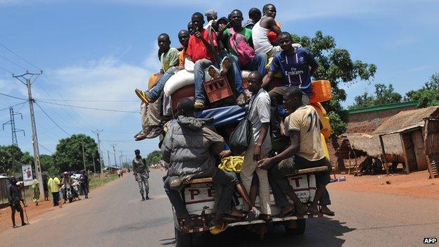 Men on a vehicle approaching an anti-balaka militia checkpoint on 2 March 2014 in Bangui