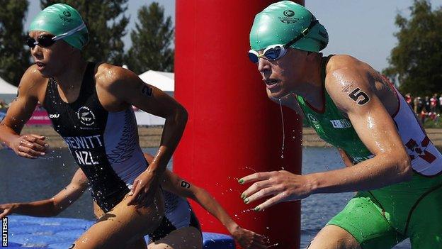 Andrea Hewitt of New Zealand and Northern Ireland's Aileen Reid emerge from the water