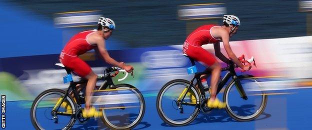 Alistair Brownlee leads his brother on their bikes as they pulled away from the field