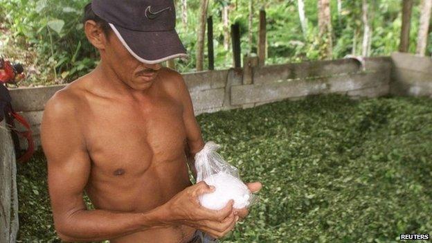 Colombian peasant holds bag of cocaine