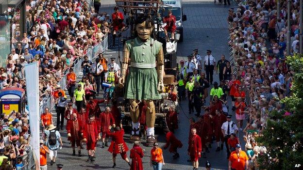 The girl giant marionette is steered through the centre of Liverpool