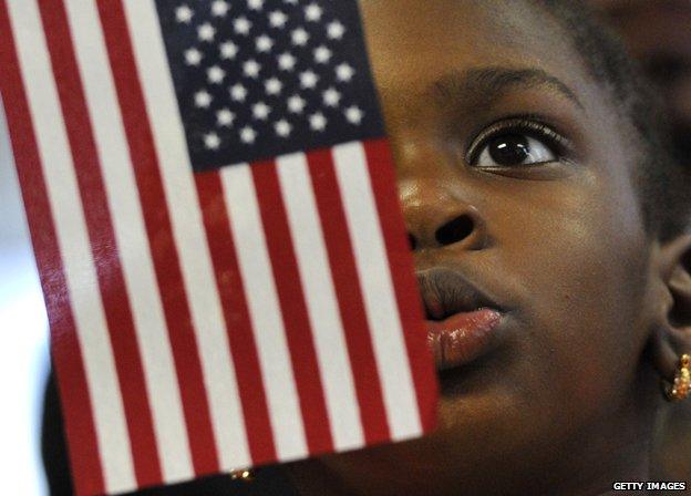 Child with flag at US naturalisation ceremony