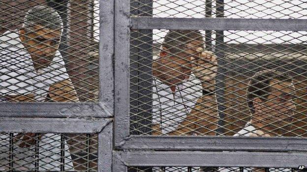 Canadian-Egyptian acting Al-Jazeera bureau chief Mohammed Fahmy (left), Australian correspondent Peter Greste (centre) and Egyptian producer Baher Mohamed in court in May 2014