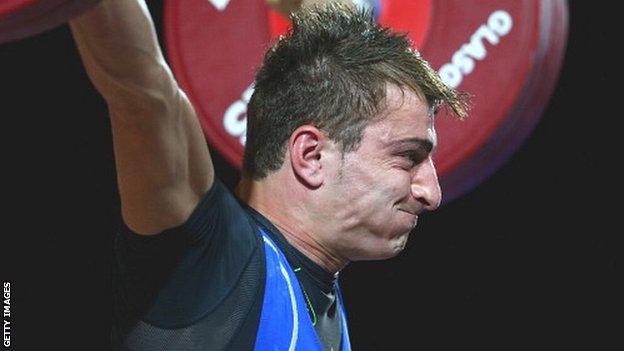 Dimitris Minasidis of Cyprus competes in the Men's 62kg Weightlifting