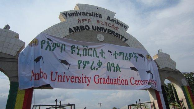 Ambo University's entrance with a sign about a forthcoming graduation ceremony