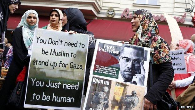 Female Muslim demonstrators hold placards during a protest against the Israeli assault on the Gaza Strip - 25 July 2014