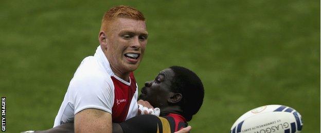 England's James Rodwell is tackled during the rugby sevens match against Uganda at the 2014 Commonwealth Games