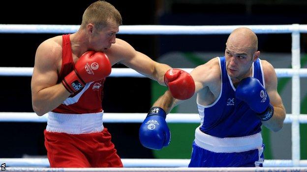 Northern Ireland heavyweight Steven Ward attempts to avoid a left hand from England's Warren Baister in Sunday's bout