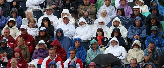 Fans watch in the rain at the Kelvingrove Lawn Bowls Centre at the 2014 Commonwealth Games