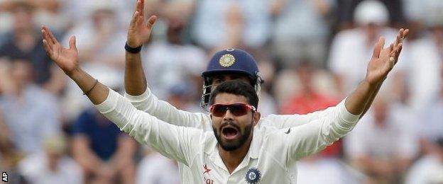 India celebrate the dismissal of Alastair Cook