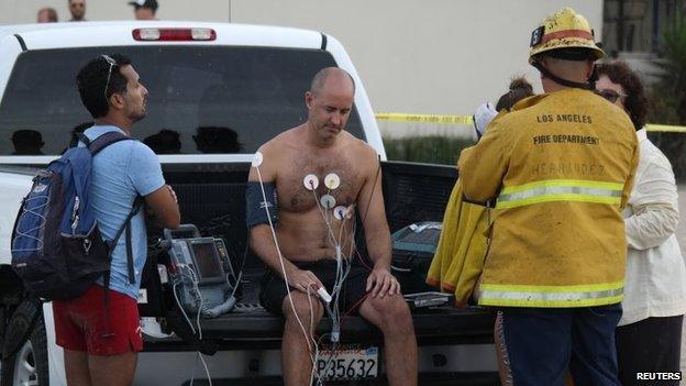 A man is treated by a paramedics after a lightning strike in the water in Venice