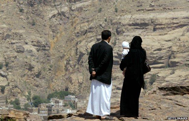 Yemeni couple holding child