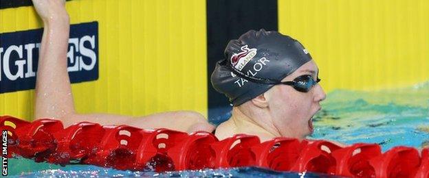 Sophie Taylor of England reacts after winning 100m breaststroke gold