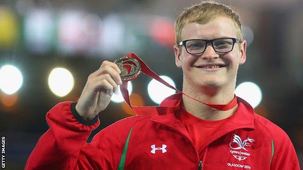 Rhys Jones shows off the bronze medal he won in the T37 100m final at the Commonwealth Games