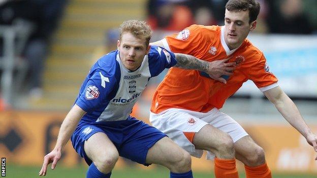 Blackpool's Jack Robinson (right) and Chris Burke (left) tussle for possession