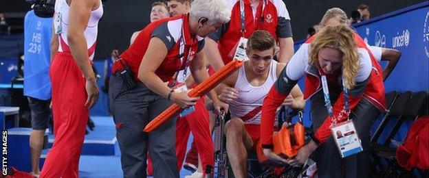 Sam Oldham in a wheelchair after falling in the vault