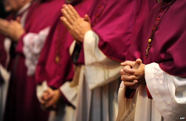 Hands of clergy in prayer