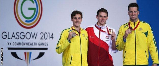 England's Ben Proud after winning gold, with Australians Cameron McEvoy, 20, and James Magnussen, 23