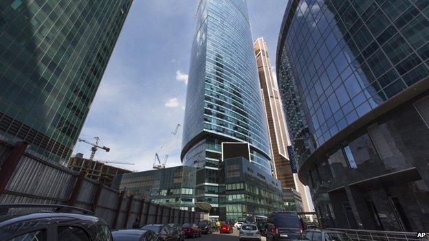 The main VTB Bank building, centre, rises between skyscrapers of the "Moscow City" in Moscow, Russia, on 29 July 2014