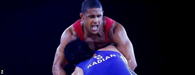 England's Leon Rattigan (red) and India's Satywart Kadian in the 97kg semi-final